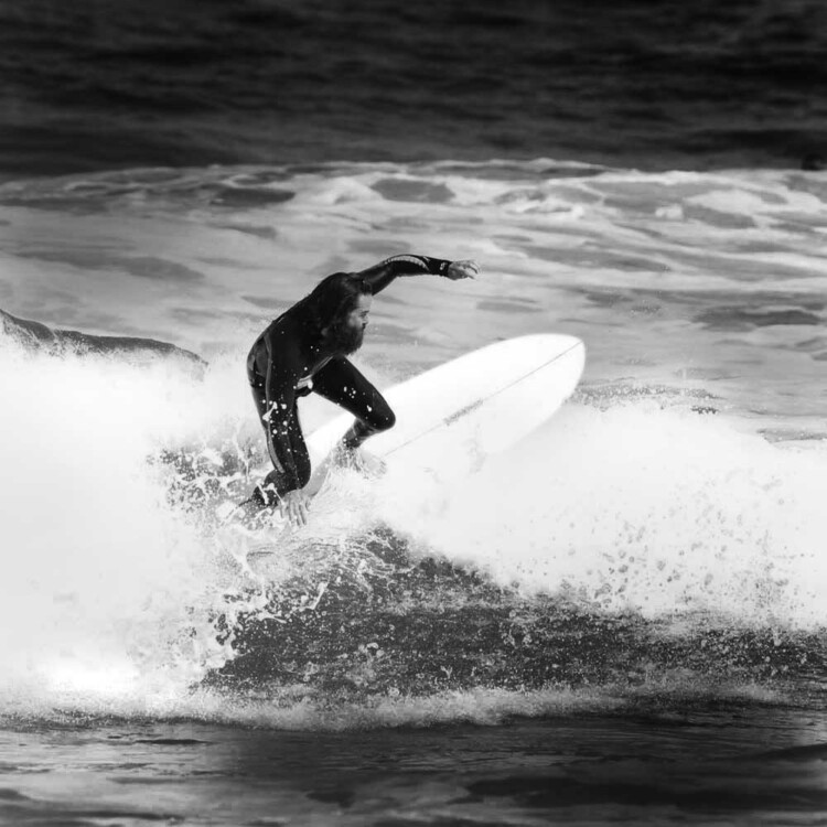 California artist Matt Beard climbing the foam on a small wave in southern California