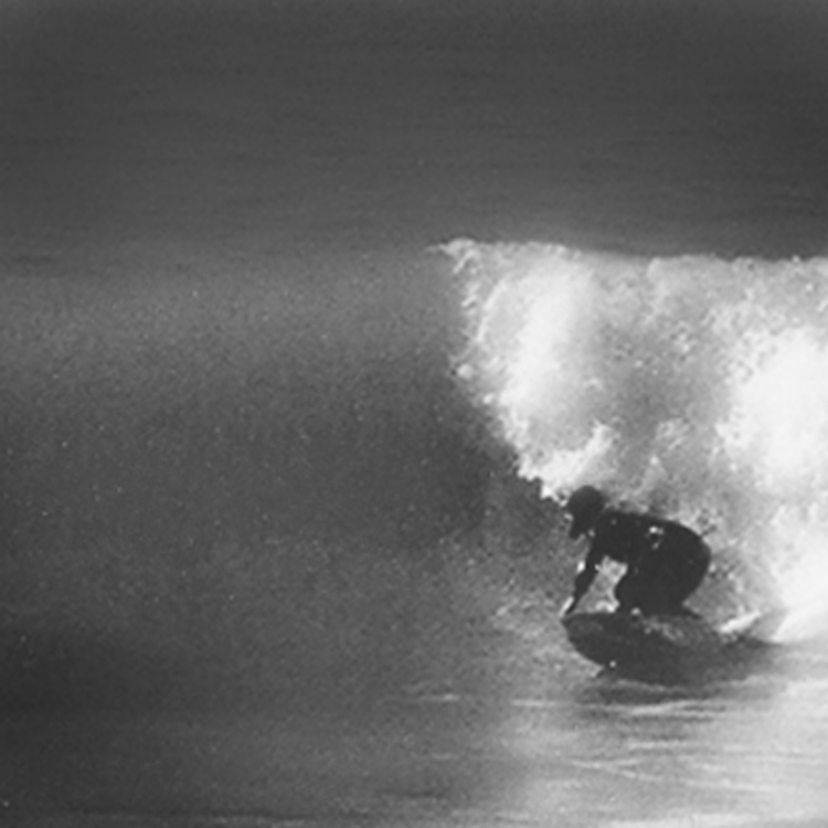 Artist Matt Beard leans off the bottom of a wave in Northern California