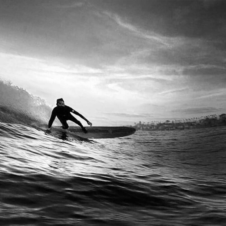 Artist Matt Beard glides into a wave in southern California